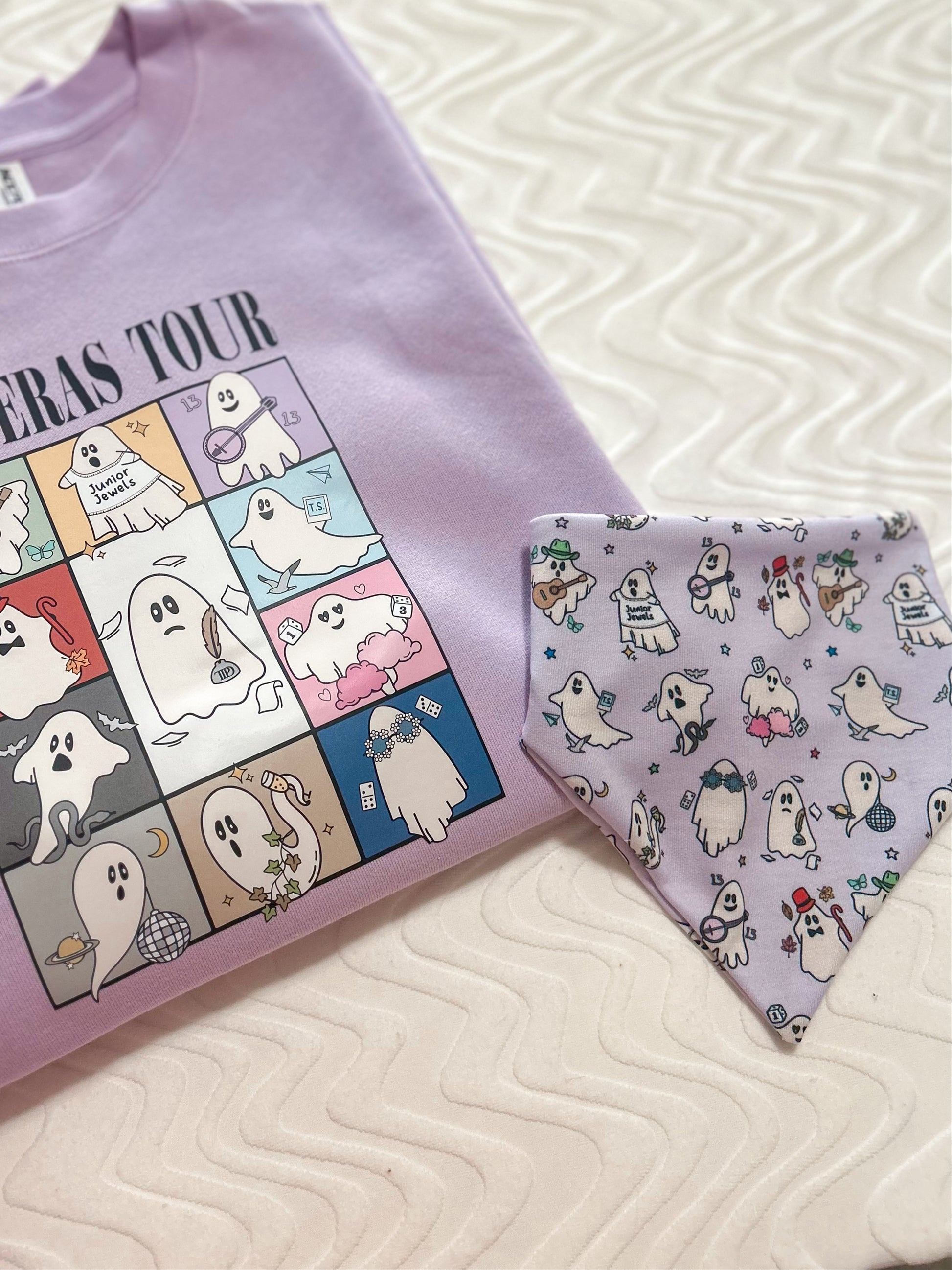 Purple t-shirt with cartoon ghost design and matching bandana on a textured surface.