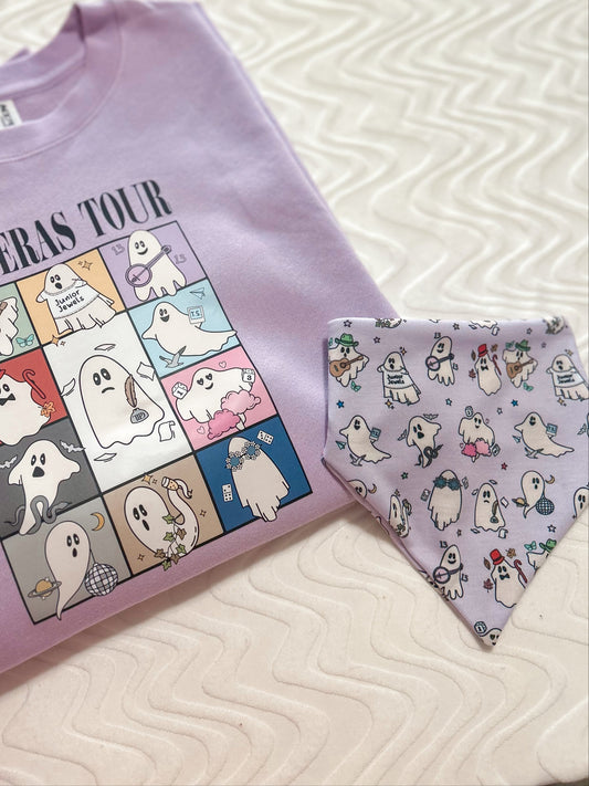 Purple t-shirt with cartoon ghost design and matching bandana on a textured surface.